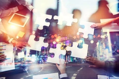 Teamwork of partners. Concept of integration and startup with puzzle pieces Stock Photos