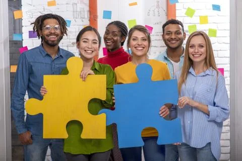 Teamwork of partners. Concept of integration and startup with puzzle pieces Stock Photos