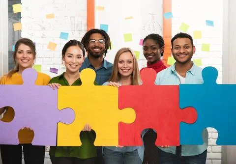 Teamwork of partners. Concept of integration and startup with puzzle pieces Stock Photos