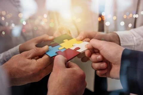 Teamwork of partners. Concept of integration and startup with puzzle pieces Stock Photos