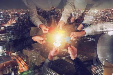 Teamwork of partners. Concept of integration and startup with puzzle pieces Stock Photos
