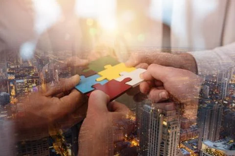 Teamwork of partners. Concept of integration and startup with puzzle pieces Stock Photos