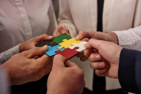 Teamwork of partners. Concept of integration and startup with puzzle pieces Stock Photos