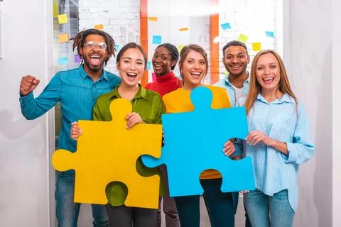 Teamwork of partners that work with puzzle as integration and startup concept Stock Photos