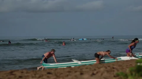 Teamwork, people pulling boat from water to coast, sunny day Stock Footage 57402990
