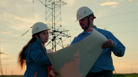 Teamwork of power engineers in protective helmets, maintenance of power lines in Stock Footage 241914593