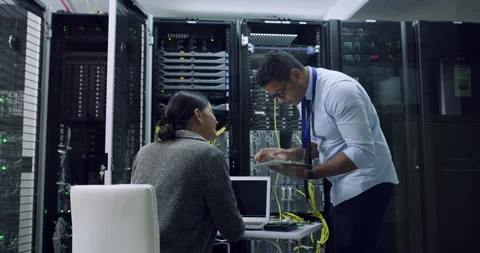 Teamwork, problem solving and data center, woman and man with tablet, laptop and Stock Footage 243025627