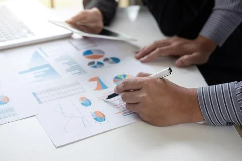 Teamwork process, Business adviser analyzing financial figures denoting the p Stock Photos