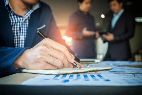 Teamwork process, Businessmen hands pointing at document and touchpad during Foto stock
