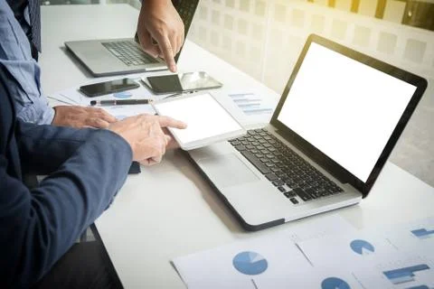 Teamwork process, Businessmen hands pointing at tablet and document during ex Stock Photos
