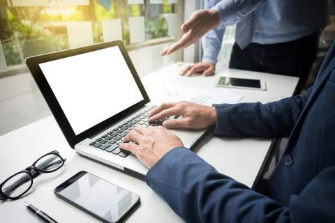 Teamwork process, Businessmen hands pointing at laptop and document during ex Foto stock