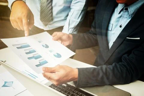 Teamwork process, Businessmen hands pointing at tablet and document during ex Stock Photos