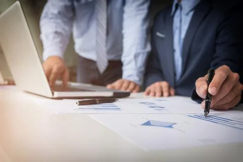 Teamwork process, Young businessmen hands pointing at document and laptop dur Stock Photos