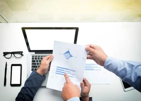 Teamwork process, Young businessmen hands pointing at document and laptop dur Stock Photos