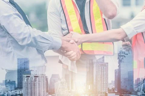 Teamwork professional of civil engineer builder shake hand join to working to Stock Photos