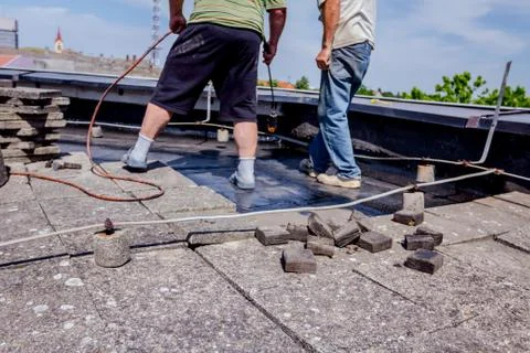 Teamwork at roofing installation resin Stock Photos