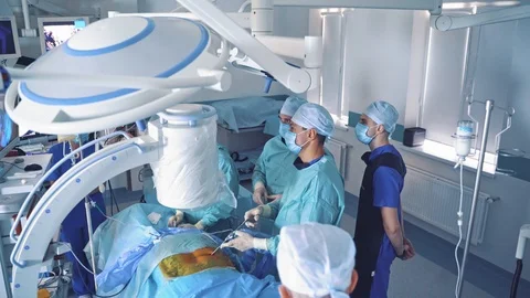 Teamwork of surgeons performing an operation. Surgery room with male specialists Stock-Footage 112221557