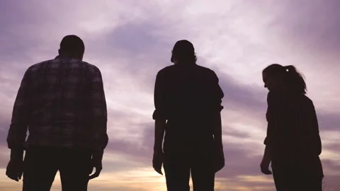 Teamwork. team community hold hands together silhouette at sunset unity. group Video stock 132598060