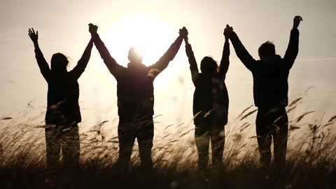 Teamwork. team community hold hands together silhouette at sunset unity. group Video stock 227726962