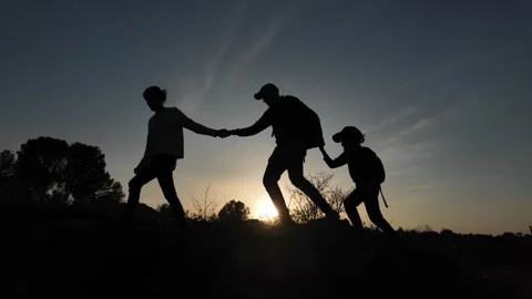 Teamwork Triumphs as Three Brave Souls Conquer the Mountains Video stock 270453048