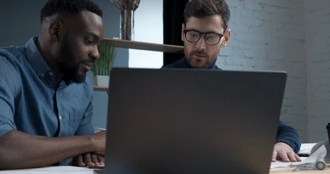 Teamwork of two IT Engineers are working on Laptop in modern Office. Two IT Stock Footage 126162767
