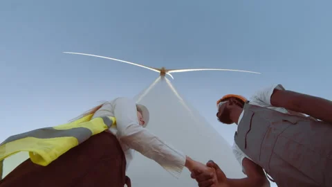 Teamwork of windmill engineer group, worker working, shaking hands on site at Stock Footage 170605162
