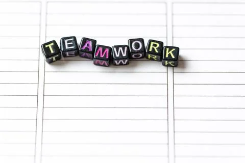 Teamwork word from blocks on clean page notebook close up. Stock Photos