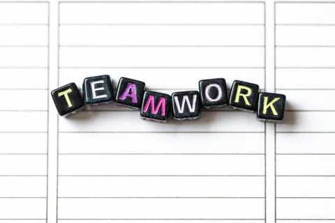 Teamwork word from blocks on clean page notebook close up. Stock Photos