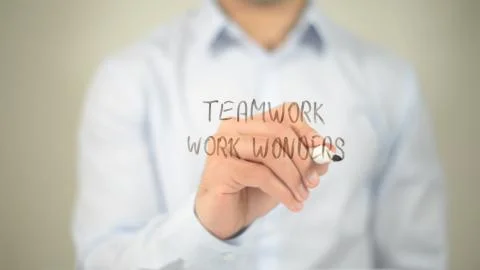 Teamwork Work Wonder , man writing on transparent screen Stock Photos