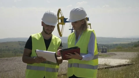 Teamwork of young proactive successful engineers in oilfield industry analyzi Stock Footage 82179215