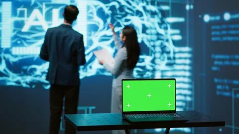 Teamworking AI technicians using green screen laptop for business data analysis Stock Photos