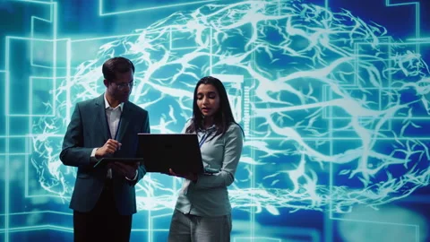 Teamworking colleagues using AI neural networks modeled after human brain Stock Footage 278697159