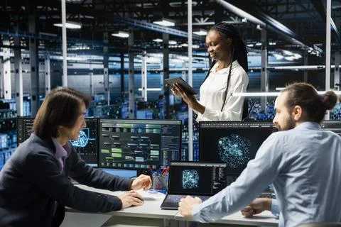 Teamworking data center admins adjusting neural networks model parameters Stock Photos
