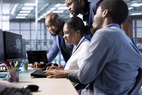 Teamworking data center employees collaborating to implement AI driven solutions Stock Photos