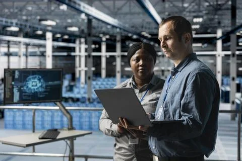 Teamworking data center technicians resolving technical issues Stock Photos