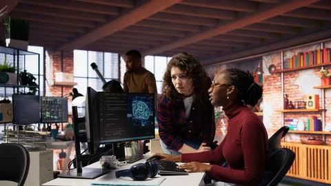 Teamworking engineers coding advanced AI algorithm in startup Stock Photos