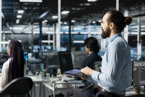 Teamworking engineers in data center installing server systems helped by AI Stock Photos