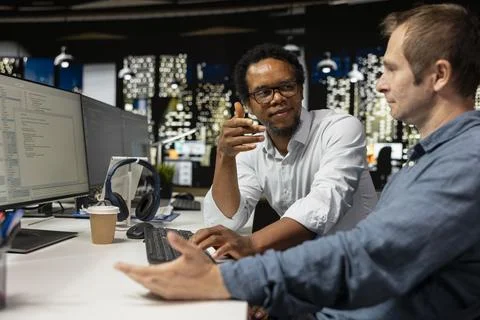 Teamworking engineers talking in startup office, coding Stock Photos
