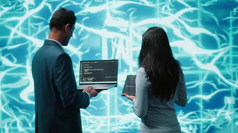 Teamworking IT staff members using AI system aiding in processing Stock Footage 278625906