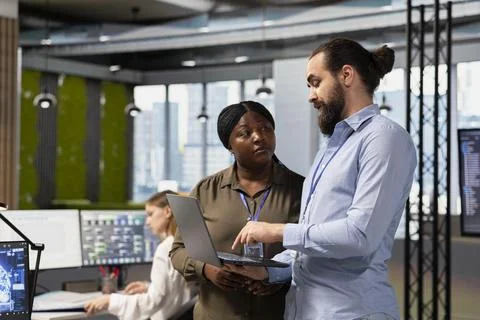 Teamworking programmers collaborating at work to train deep learning models 写真素材