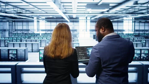 Teamworking programmers in data center overseeing server operations Stock Footage 277655994