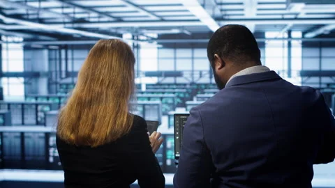 Teamworking programmers in data center overseeing server operations Stock Footage 277656116