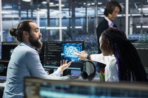 Teamworking programmers in data center troubleshooting issues using AI Stock Photos