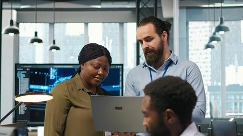 Teamworking programmers in office reviewing AI system metrics Stock Photos