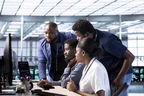 Teamworking server farm IT specialists debugging and optimizing code Stock Photos