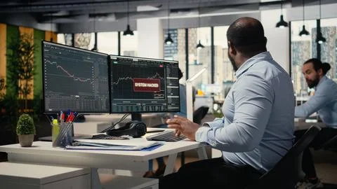 Teamworking traders in office work together to resolve hacker security alert Stock Photos