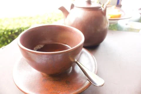 Teapot and cup on a table Stock Photos