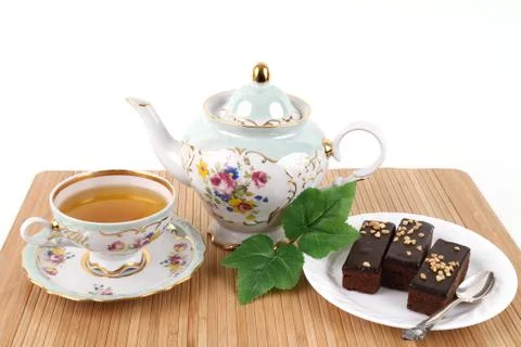 Teapot and cup of tea with brownies Stock Photos