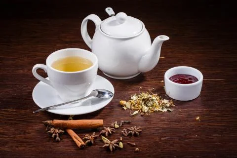 Teapot and a cup of tea Stock Photos