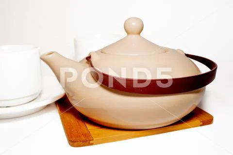 Teapot and mugs Stock Photos